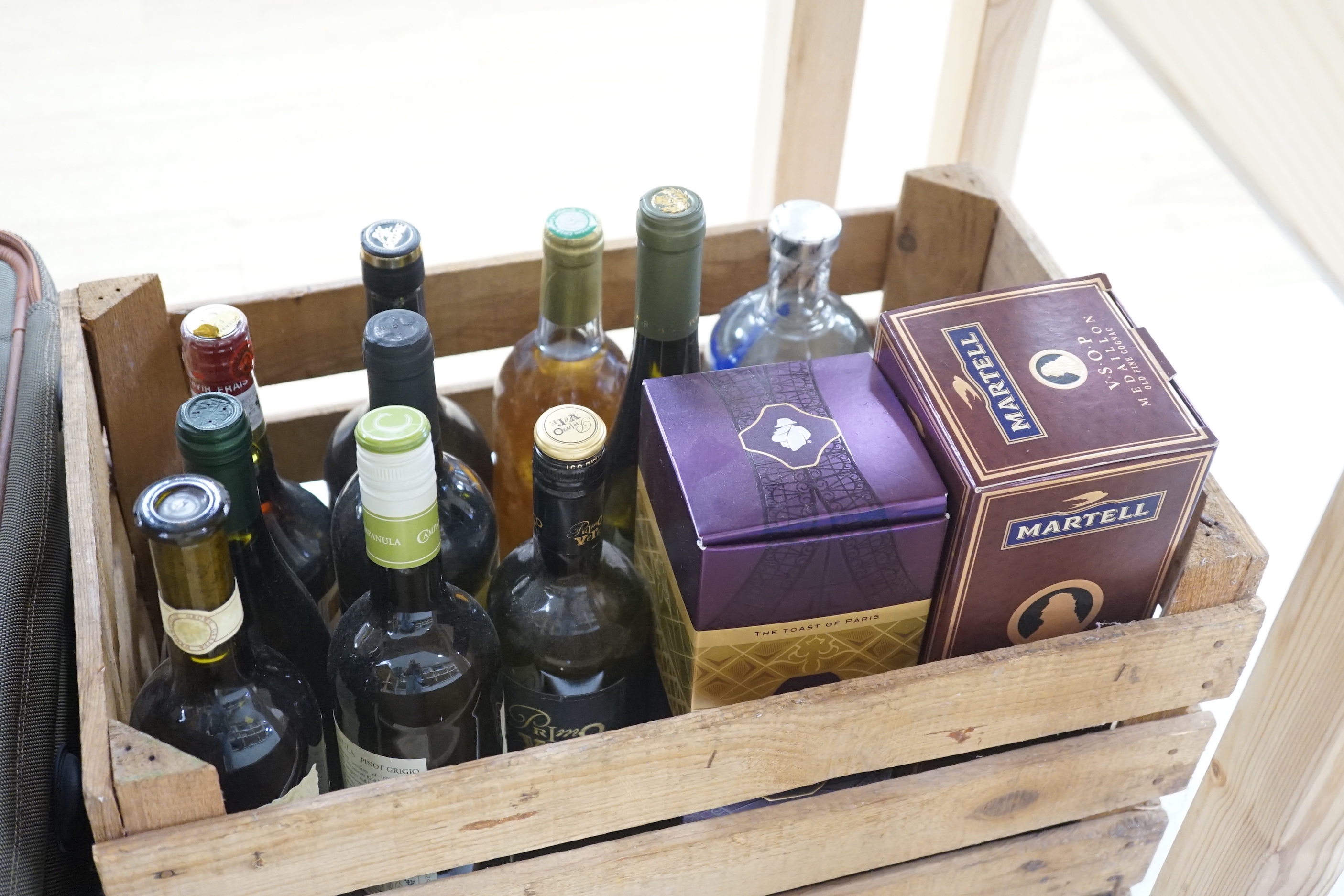 A crate of wine and spirits including Absolut Vodka